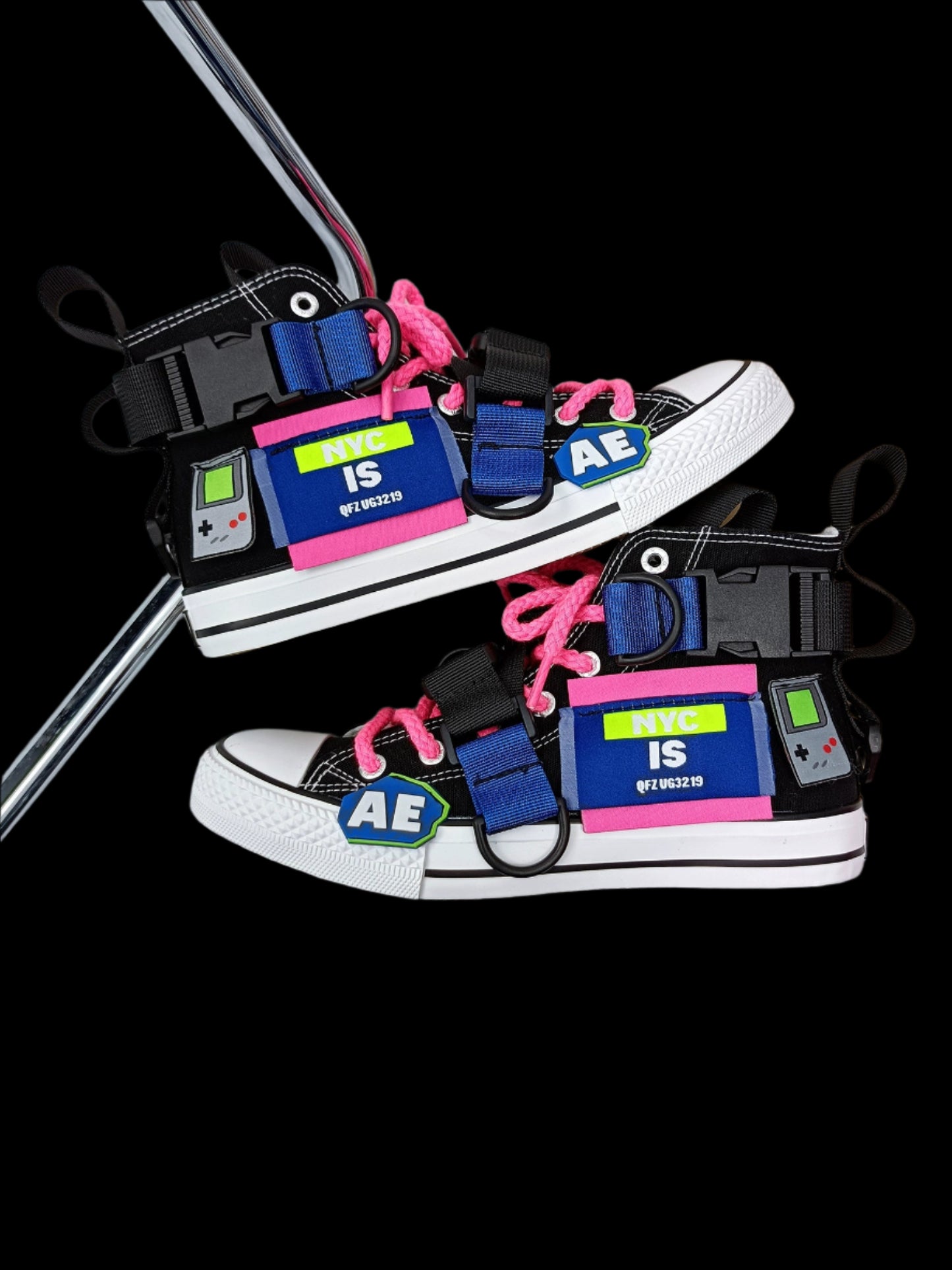 Pair of sneakers with unique designs and text on a white surface.